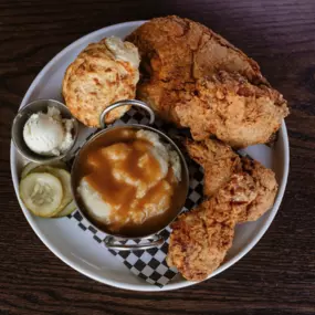 fried half bird with two fresh sides