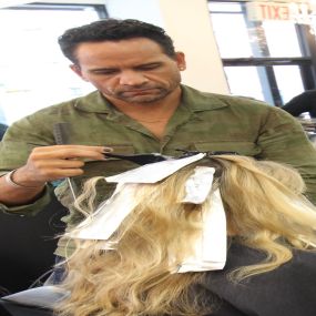 Joseph working on a customers hair