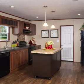 Spacious mobile home kitchen with custom cabinets.