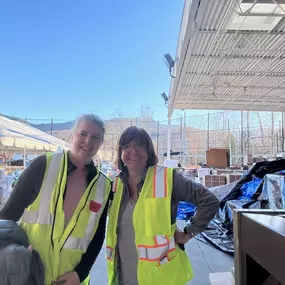 Picture of myself volunteering with a friend in Black Mountain Catastrophe distribution center where people in need could come for supplies such as food, water, baby supplies, clothes, camping equipment