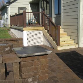 Deck replacement with new Belgard paver patio and Azek railing.  Gas firepit and bench seat wall.