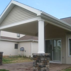 Open porch trimmed with Azek, with new Belgard Dublin Cobble paver patio