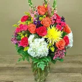 A lovely collection of all our favorite flowers designed in a clear glass vase. Featuring imported roses along side hydrangea, fragrant stock, long lasting carnations and more. Each day we will use the freshest flowers in bright bold colors, exact flowers may vary.