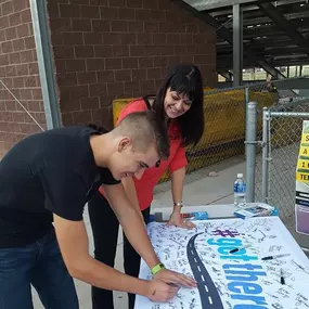 X the TEXT! Students and parents pledge to stop texting and driving at a local high school football game.