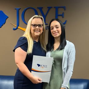 Attorney Fay Johnson presenting a student with our scholarship award winner package. Each Year Joye Law Firm gives out 7 $2,000 scholarships to deserving South Carolina high school seniors.