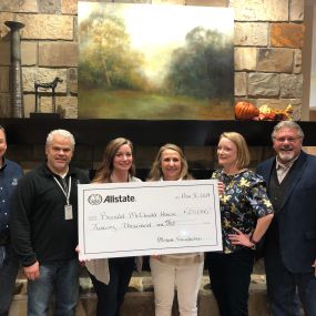 Jennifer King, Allstate Insurance Agent in Little Rock, AR presents check to Charity.