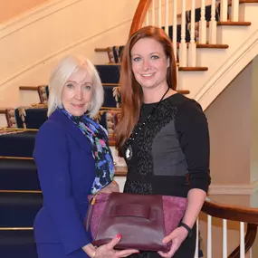 Jennifer King, Allstate Insurance Agent in Little Rock, AR presents presents purse to former First Lady of Arkansas, Ginger Beebe, as part of Allstate's Purple Purse Campaign.