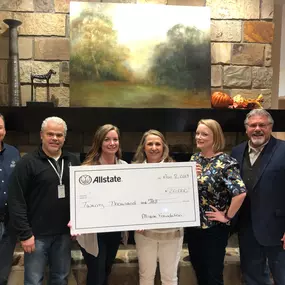 ennifer King, Allstate Insurance Agent in Little Rock, AR presents check to  Charity.