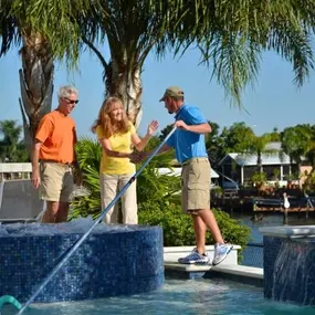 Pool Troopers Technician Servicing a Pool and Speaking with a Customer