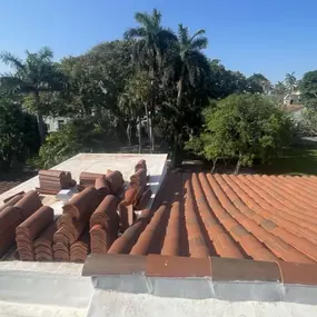 Close up view of a tile roof being worked on.