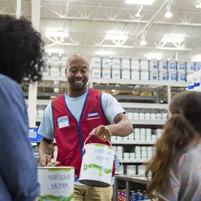 Lowe's team member providing customers with Valspar paint.