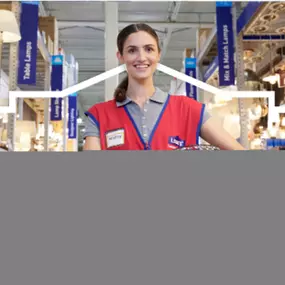 Lowe's team member assisting customers at DIY workshop.