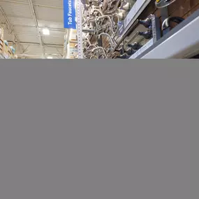 Lowe's team member assisting kids at Build and Grow workshop.