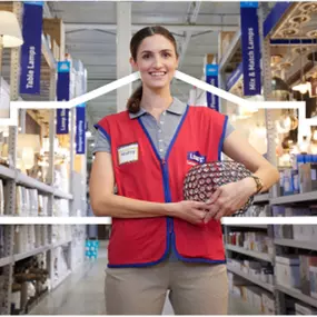 Close up of Lowe's employee smiling holding a light fixture.