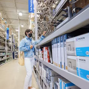 Customer shopping for faucets at Lowe's.