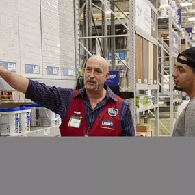 In-store photo of Lowe's weekend event with games and outdoor products.