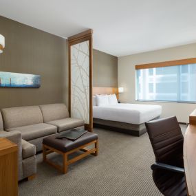 The king guestroom features a separate sleeping and living area, with mini-refrigerator, single serve coffee maker, free Wi-Fi, and a Cozy Corner with sofa sleeper.