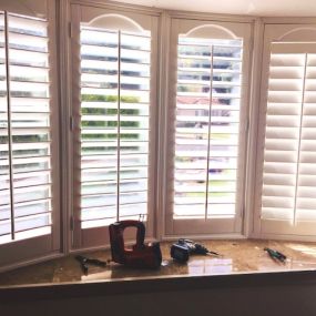 Shutters in a bay window with decorative liberty bells