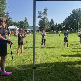 Miss Cotten teaching beginner Bo Staff skills to the kids that came to visit our River Fest Booth!