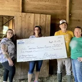 In June 2023, we were proud to organize a volunteer day where we installed fence posts for their goats, in the rain, and to present a check to support the Tamerlaine Sanctuary.