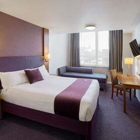 Premier Inn bedroom with double bed, sofa and flat screen TV