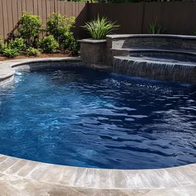 Get inspired by a freeform pool with an amazing raised spillover spa
