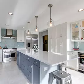 Two finish kitchen cabinets in white and blue-gray finishes.