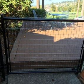 Metal frame gate with rolled horse fence instead of chain link for a more modern look