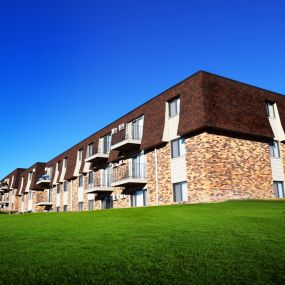 West side of the apartment building facing boxelder Rd looking out over a large grass field.