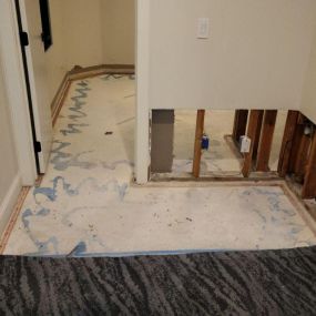 Pictured here is Minneapolis water damage restoration in a basement laundry room.  The utility sink water line froze and burst, leaving 2 inches of water on the floor before it was shut off.