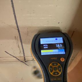 Pictured here is a moisture meter for Minneapolis water damage.  We use a moisture meter to detect water behind walls.  As you can see, this area of drywall is 18% wet.