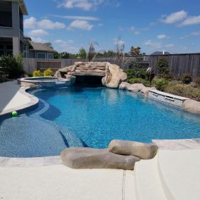 New pool stone with coping around edge, spa, waterfall with slide, Cypress, TX