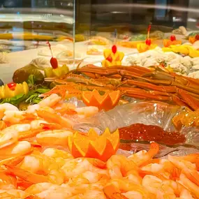 A lavish seafood display at Slacks Oyster House, featuring an array of fresh shrimp, crab legs, and oysters. The presentation is colorful and inviting, reflecting the restaurant's commitment to offering the finest seafood available.