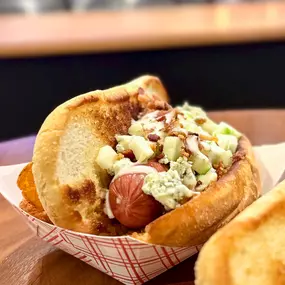 Dead Dixie Dog: Grilled Dog, Toasted Bun, Diced Granny Smith Apples, Blue Cheese Crumbles, Bacon Bits, Drizzled with Ranch Dressing.