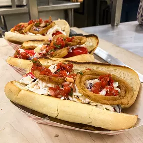 The Maniac: Grilled Red Snapper Dog, Toasted Bun, Coleslaw with Green Goddess Dressing, Crispy Onions, Red Pepper Relish.