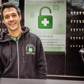 A friendly locksmith waits to greet a customer at our locksmith shop in Portland.