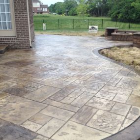 Stamped Concrete Patio in Maineville Ohio with Seating Walls Columns and Fire Pit also has two Concrete Steps