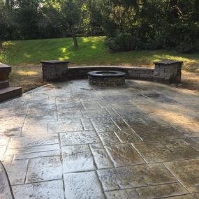 Loveland Ohio Stone Fire Pit on a Stamped Concrete Patio also has Seating Walls and Columns with Custom made Concrete Caps.