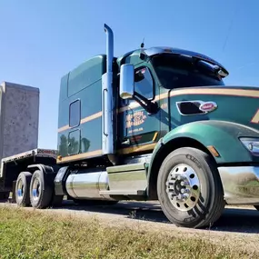 A Morrell Transfer semitruck is leading a convoy down a rural road, transporting a massive concrete structure on its flatbed trailer.