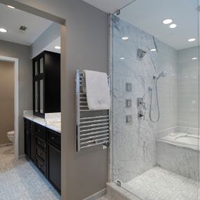 Espresso finish bathroom cabinets and walk in shower and tub combination.
