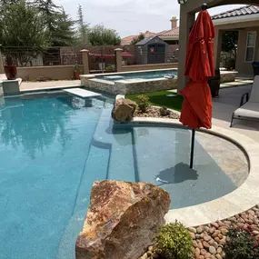 Custom inground pool with tanning ledge and spa