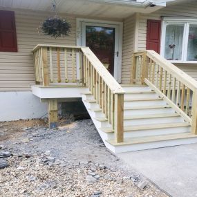 Completed Job in Andover, NJ. Both the decking and the railing system were replaced on this front porch with pressured treated wood. White PVC trim board was also added on the trim and the risers to top off this job!