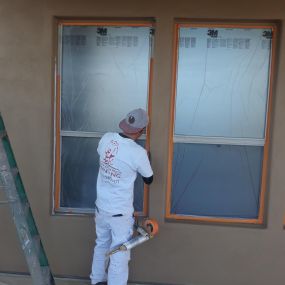 Masking windows before paint is applied.