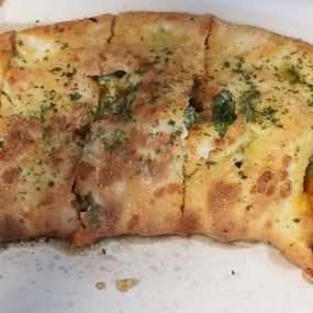 Calzone! Our calzones come with pizza sauce, mozzarella cheese, and ricotta cheese. Add any toppings or make your favorite pizza into a calzone!