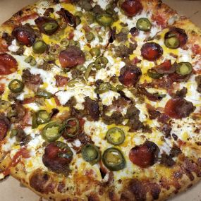 Fan Creation with all-beef pepperoni, Italian sausage, bacon, jalapenos, cheddar, extra mozzarella and green olives added to half!