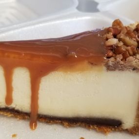 Caramel Fudge Cheesecake! A classic New York Cheesecake with a layer of caramel on top with candied roasted pecans and a thin layer of fudge on the bottom above the graham cracker crust!