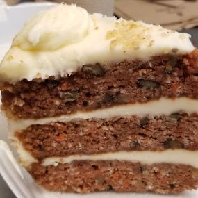 Colossal Carrot Cake with layers of rich cream cheese icing throughout!