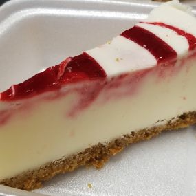 Classic New York Cheesecake with strawberry glaze drizzled on top!