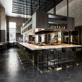 Its interior, designed by the Houston office of Gensler, is evocative of an Italian Villa with a modern twist, featuring a spacious bar alongside the main dining space.