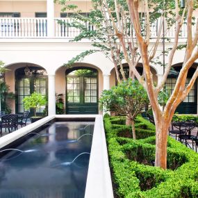 Garden courtyard at the Planters Inn luxury Charleston hotel.